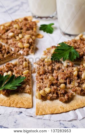 Traditional Asian thin tortilla with minced meat and pine nuts. Selective focus.