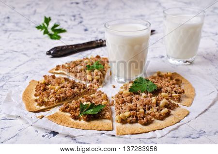 Traditional Asian thin tortilla with minced meat and pine nuts. Selective focus.