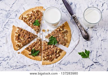 Traditional Asian thin tortilla with minced meat and pine nuts. Selective focus.