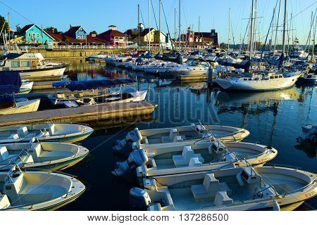 June 20, 2016 in Long Beach, CA:  Row of rental boats docked at the Long Beach Harbor where people can enjoy traveling on the rental boats in the bay and marina taken at Shoreline Village in Long Beach, CA