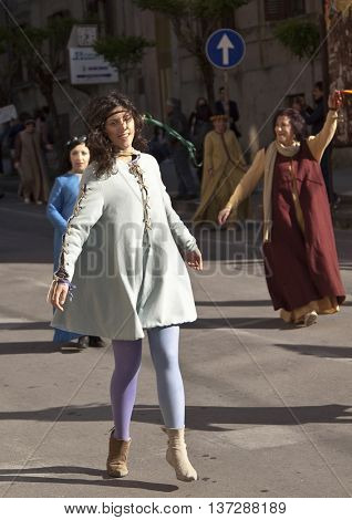 Enna, Italy - May 2016: Young girl  takes part in the medieval costume parade dancing along the street. Tenth Edition of Historical Parade, 15 may 2016, Enna, Sicily