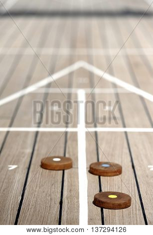 Shuffleboard game on the wooden deck of a cruise ship