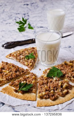 Traditional Asian thin tortilla with minced meat and pine nuts. Selective focus.
