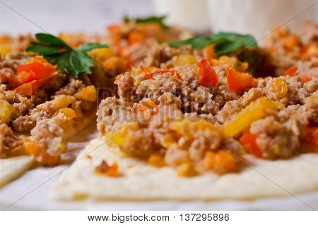Traditional Asian thin tortilla with minced meat and vegetables. Selective focus.