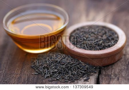Caraway seeds with essential oil in glass bowl