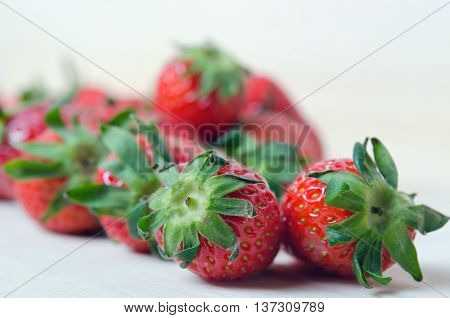 Strawberry fruit with flash filled on wooden board (Other names are Fragaria strawberry Fragaria ananassa)