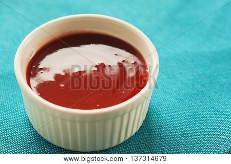 Red Sauce In White On A Blue Background