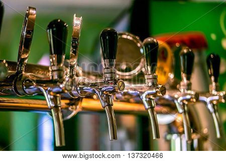 Beer taps in a pub. Close up of beer Tap. Selective focus.