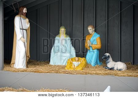 PLAINFIELD, ILLINOIS / UNITED STATES -DECEMBER 29, 2015: Mary, Joseph and a shepherd adore the baby Jesus in a nativity scene outside of the Plymouth Congregational Church in downtown Plainfield.