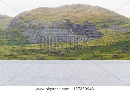 Cwmystradllyn Slate Quarry with reservoir in foreground.