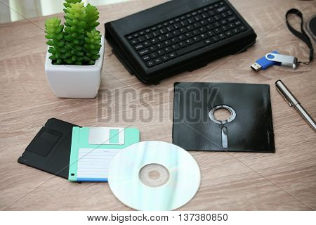 desk with note ,floppy disk A, floppy disk B and memory drive in home office, private office and modern desk in modern life, online market and planning for work, document and paper on desk.