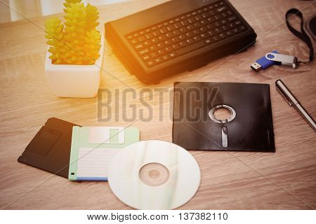 desk with note ,floppy disk A, floppy disk B and memory drive in home office, private office and modern desk in modern life, online market and planning for work, document and paper on desk.