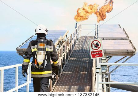 Fire fighter on oil and gas industry, successful firefighter at work , Fire suit for fighter with fire and suit for protect fire fighter, Security team when fire case. restricted area or danger area.