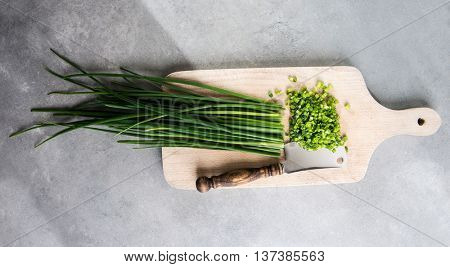 Chopped chives on cutting board