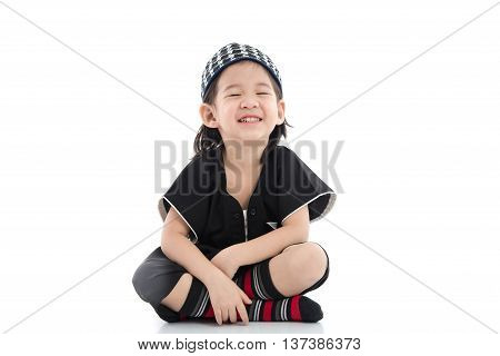Cute muslim chlid sitting on white background isolated.