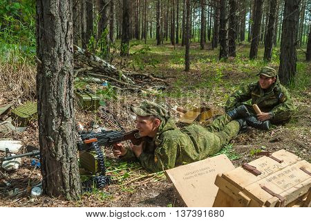 Tyumen, Russia - June 11, 2016: Race of Heroes project on the ground of the highest military and engineering school. Machine gunners ambush in forest