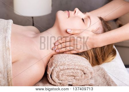 Caucasian woman having classic Face massage. Spa Salon rejuvenating Face massage
