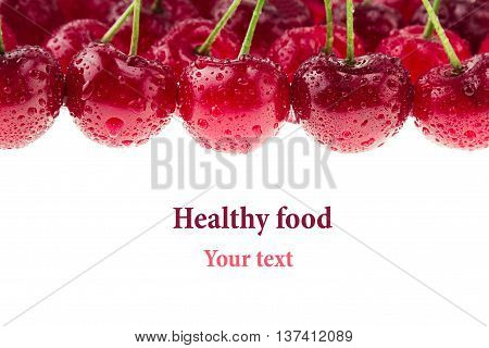 Cherry background. Bunches of ripe juicy rich shiny cherries on a white background. Isolated. Decorative fruit frame. Fresh ripe cherries with water drops. Fruit background. Copy space.