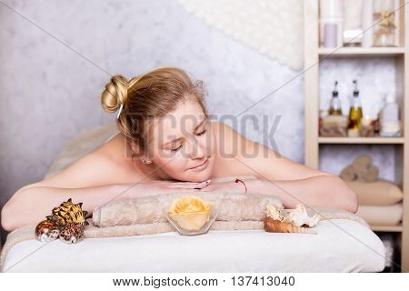 healthy and beautiful blond woman in spa salon. Traditional oriental aroma therapy and beauty treatments.