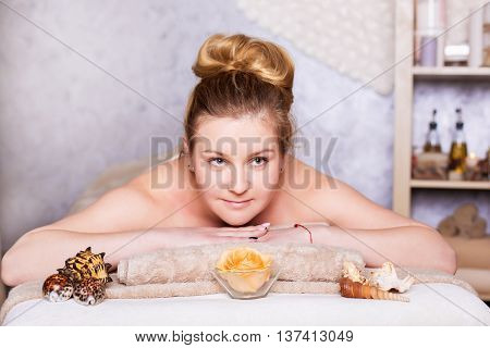 healthy and beautiful blond woman in spa salon. Traditional oriental aroma therapy and beauty treatments.