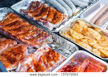 Different tasty grilled meat and sausages on a grill