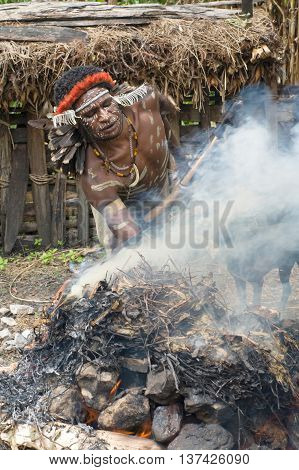 Warrior Of A Papuan Tribe In Traditional Clothes And Coloring
