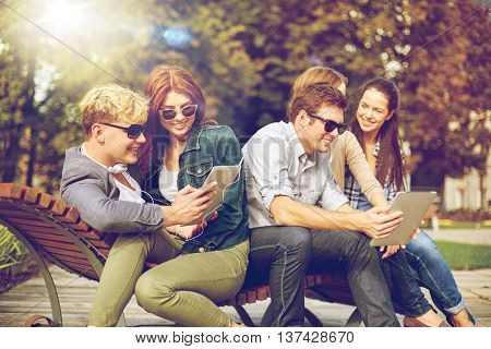 summer, technology, education and teenage concept - group of happy students or teenagers with tablet pc computer taking selfie