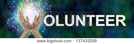 Put your sparkle into Volunteering -  wide banner with a woman's hands in an open position making the V of  the word VOLUNTEER on a dark green blue wide background with sparkles behind