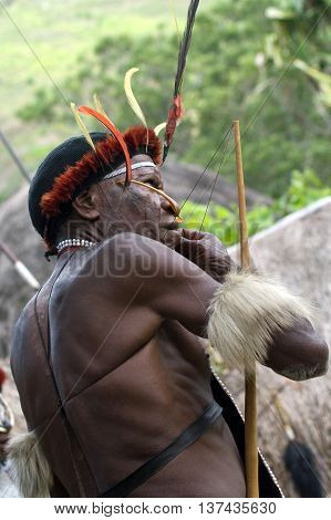 NEW GUINEA INDONESIA -DECEMBER 28: The warrior of a Papuan tribe in traditional clothes and coloring in New Guinea Island Indonesia on December 28 2010