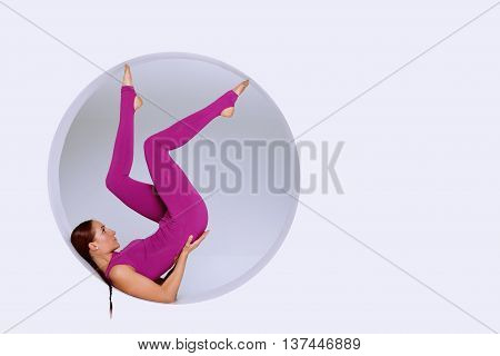 stylish and sporty woman practicing gymnastic exercises in geometric design of round shapesin sphere. Creative concept sports white background. Empty space for text