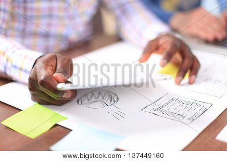 Close-up image of an office worker using a touchpad to analyze statistical data