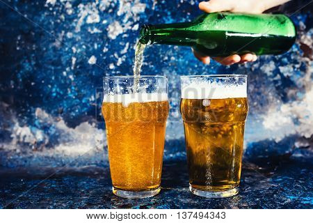 Barman Hand With Beer Bottle Pouring A Draught Lager Beer