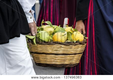 SELARGIUS, ITALY - September 13, 2015: Former marriage Selargino - Sardinia - basket of citrus fruits brought by two guys in traditional Sardinian costume