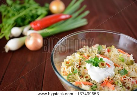 White cabbage salad with onion, carrot, pepper and olives
