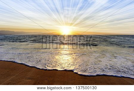 Ocean sunset sun rays is a brightly lit golden orange seascape with a burst of sun beams as a gentle wave rolling to the shore.