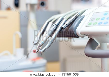 Dental Tools On Dentist Chair With Medical Equipment And New Tec