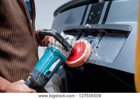 Professional Mechanic Cleaning The Metal Surface Of The Bodywork