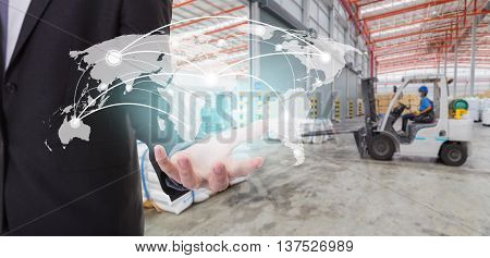 Global network coverage world map on hand of businessman Distribution of goods in warehouse process for Logistic Import Export background (Elements of this image furnished by NASA)