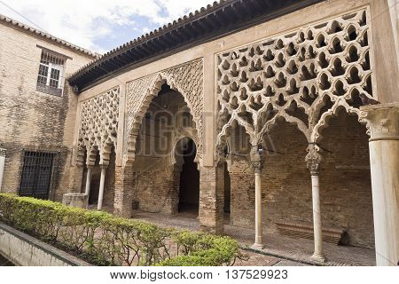 SEVILLE, SPAIN - September 12, 2015: The Almohad Palace seen from the Patio del Yeso in the Alcazar Royal of Seville on September 12, 2015 in Seville, Spain