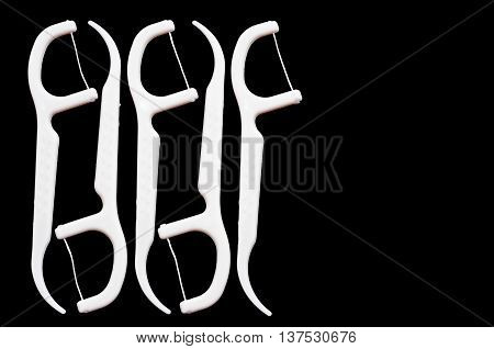 Oral Device : Dental flossers isolate on black background.