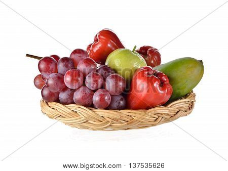 mixed fruits in rattan basket on white background
