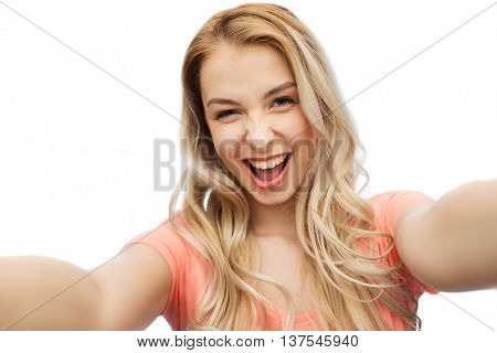 emotions, expressions and people concept - happy smiling young woman taking selfie