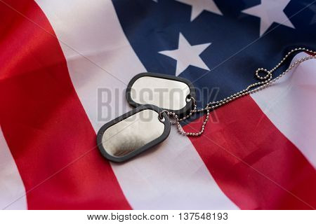 military forces, military service, patriotism and nationalism concept - close up of american flag and soldiers badges