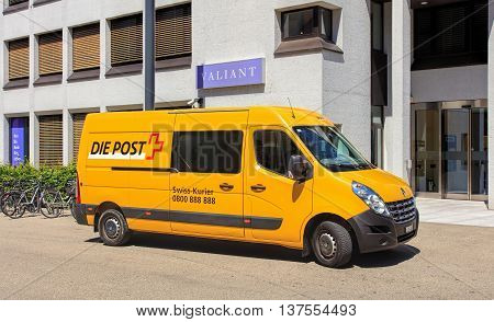 Aarau, Switzerland - 7 July, 2016: a Swiss Post van parked at the entrance to the Valiant Bank office on Schlossplatz square. Swiss Post a public company owned by the Swiss Confederation, which provides national postal service for Switzerland.