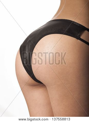 female back in sexy black lingerie on white background.