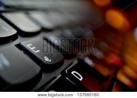 Detail of a brand new modern black laptop keyboard with the focus on the key with Euro currency(€) symbol