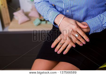 Beautiful jewelry made of silver. Female hands closeup. concept of business style clothing.
