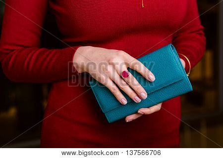 Women's hands with a nice manicure closeup. Hold wallet. Fashion and Style