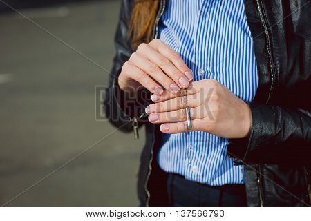 business Woman showing beautiful silver necklace. closeup hands. Concept of luxurious and wealth life