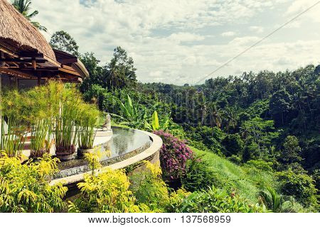 leisure, travel and tourism concept - bungalow lounge or terrace with swimming pool at hotel resort